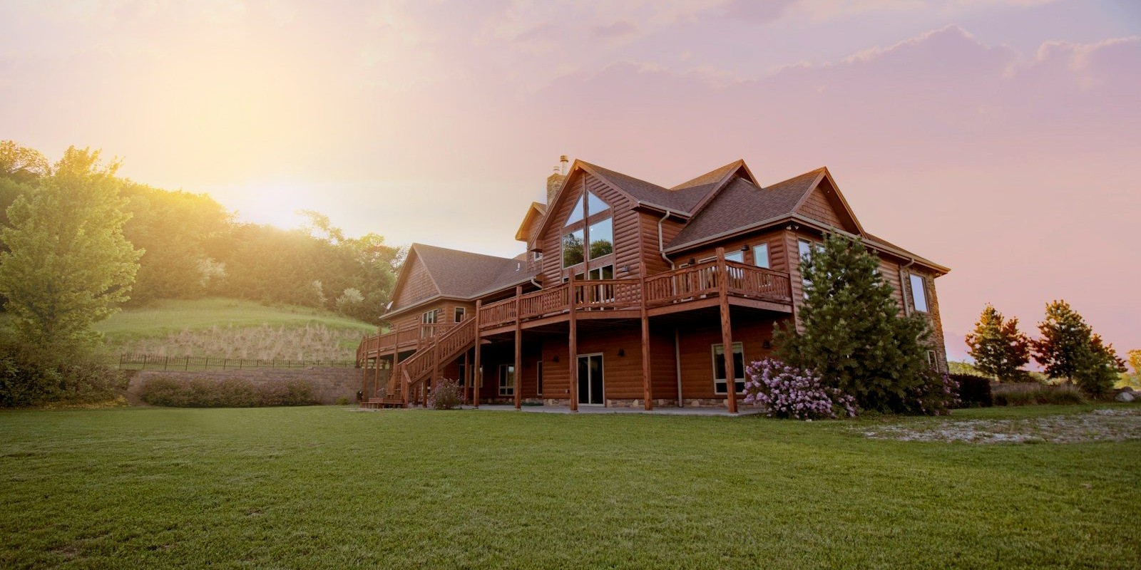 brown wooden house with green grass field