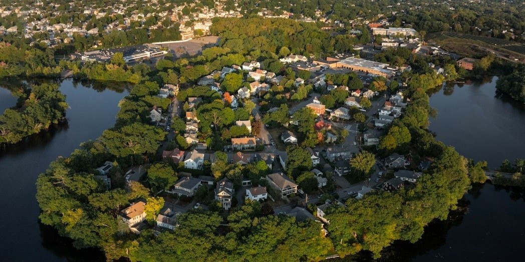 Aerial view of a peninsula neighborhood surrounded by water.
